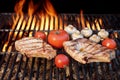 Two Tasty Rib Steaks, Tomato, Mushrooms Cooked Over BBQ Grill. Royalty Free Stock Photo