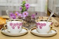 Two tea cups and chocolate on a wooden table Royalty Free Stock Photo