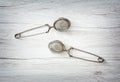 Two tea strainers on the wooden background, kitchen equipment Royalty Free Stock Photo