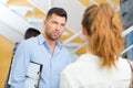 two teachers talking in school hall