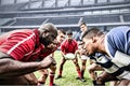 Digital composite image of team of rugby players facing each other in sports stadium Royalty Free Stock Photo