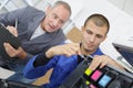 Two technicians repairing printer