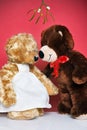 Two teddies kissing under the mistletoe