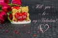 Two Teddy bears on black background with tulips and text for Valentines day