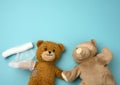 Two teddy bears on a blue background, injury, top view Royalty Free Stock Photo