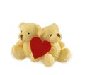 Two teddy bears with heart on white. Royalty Free Stock Photo