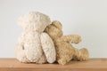 Two teddy bears love sweetness sitting on wooden table looking something. Royalty Free Stock Photo