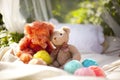 Two teddy bears - stuffed toys - and several colorful balls of yarn Royalty Free Stock Photo