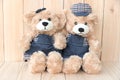 Two teddy bears on wood background Royalty Free Stock Photo