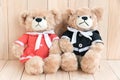 Two teddy bears on wood background Royalty Free Stock Photo