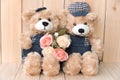 Two teddy bears on wood background Royalty Free Stock Photo