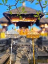 two tedung, an umbrella for odalan equipment at a family temple in Bali with a pelinggih holy place in the background