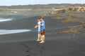 Two teen boys have fun at a black volcanic beach Royalty Free Stock Photo