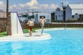 Two teen boys jump into the pool Royalty Free Stock Photo
