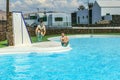 Two teen boys jump into the pool Royalty Free Stock Photo