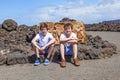 Two teen boys sitting on a rock and have a rest Royalty Free Stock Photo