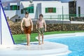 Two teen boys walk next to the pool Royalty Free Stock Photo