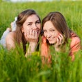 Two Teen Girl Friends Laughing in green grass Royalty Free Stock Photo