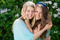 Two Teen Girl Friends Laughing in spring or summer outdoors