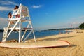 Two teen girls chat on an empty ligfeguard stand on the seashore