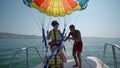 Two teen girls are excited before take off at para sailing