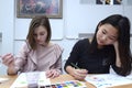 Two teen girls painting national Crimean Tartar pattern ornek on a paper, lesson in school. Kyiv, Ukraine