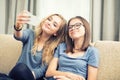 Two teen girls smile and take a selfie together Royalty Free Stock Photo