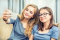 Two teen girls smile and take a selfie together Royalty Free Stock Photo