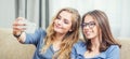 Two teen girls smile and take a selfie together Royalty Free Stock Photo