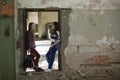 Two teen girls standing in the aisle in an abandoned building. Friendship. Royalty Free Stock Photo