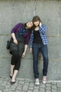 Two teen girls standing at wall Royalty Free Stock Photo