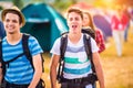 Two teenage boys with backpacks arriving at music festival