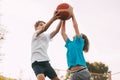 Two teenage boys play basketball on the Playground. Athletes fight for the ball in the game. Healthy lifestyle, sports Royalty Free Stock Photo