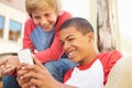 Two Teenage Boys Reading Text On Mobile Phone Royalty Free Stock Photo