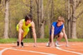 Two teenage boys ready to start running on a track