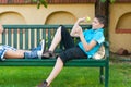 Two teenage boys throwing tennis ball outdoor in spring