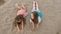 Two teenage children are lie on the beach. Royalty Free Stock Photo