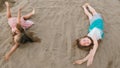 Two teenage children are lie on the beach. Royalty Free Stock Photo