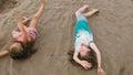 Two teenage children are lie on the beach. Royalty Free Stock Photo