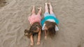 Two teenage children are lie on the beach. Royalty Free Stock Photo