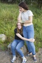 Two teenage girls are best friends hugging at the glade. Nature. Royalty Free Stock Photo