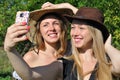 Two teenage girls in cowboy hats taking selfie Royalty Free Stock Photo