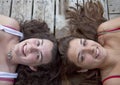 Two Teenage Girls on Dock, Head to Head Royalty Free Stock Photo