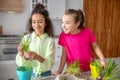 Two teenage girls enthusiastically looking at a beautiful flower.