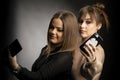 Two young women taking selfie with mobile phone Royalty Free Stock Photo