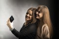 Two young women taking selfie with mobile phone Royalty Free Stock Photo