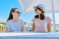 Two teenage girls in headphones listening music on smartphone, having fun Royalty Free Stock Photo