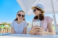 Two teenage girls in headphones listening music on smartphone, having fun Royalty Free Stock Photo