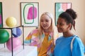 Two teenage girls looking at abtract sculpture Royalty Free Stock Photo