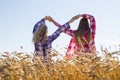 Two teenage girls making infinity sign